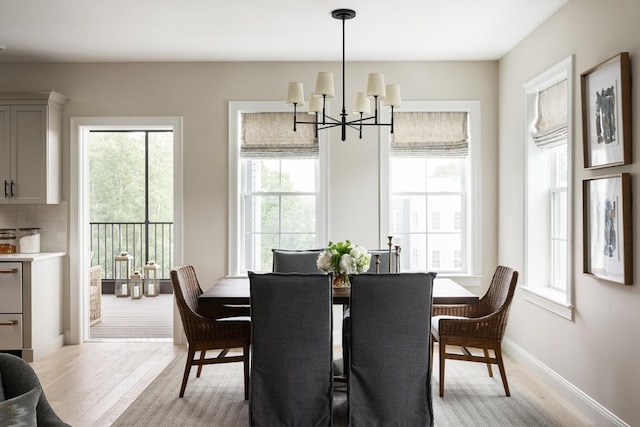 91 Miter Dr Unit 2-2, Plymouth, MA 02360 - dining room featuring baseboards, light wood-style flooring, and a notable chandelier