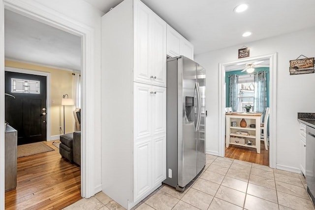 washroom featuring ceiling fan and light tile patterned flooring