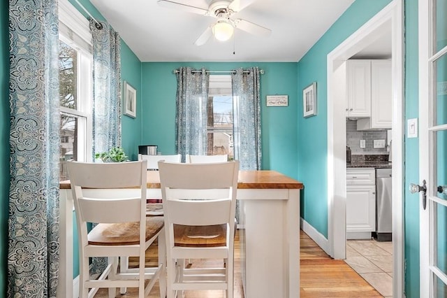 dining room with ceiling fan and light tile patterned floors