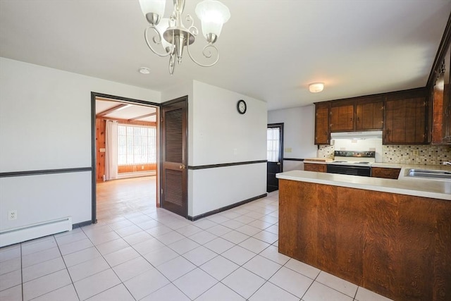 kitchen featuring electric stove, dark brown cabinetry, a wealth of natural light, and light countertops
