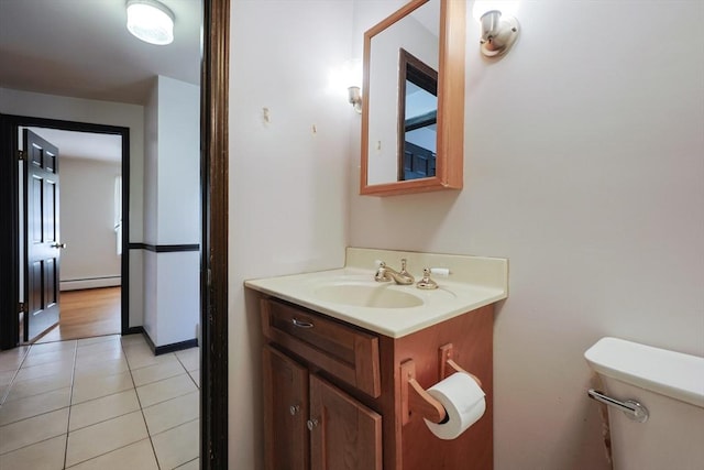 bathroom with vanity, toilet, tile patterned floors, and a baseboard radiator
