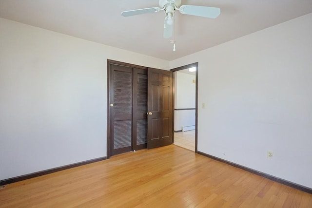 unfurnished bedroom with baseboards, a ceiling fan, a closet, and light wood-type flooring