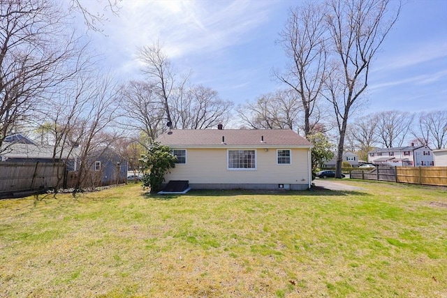 back of house featuring fence and a yard