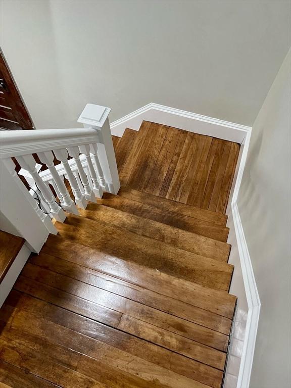 stairs with hardwood / wood-style flooring