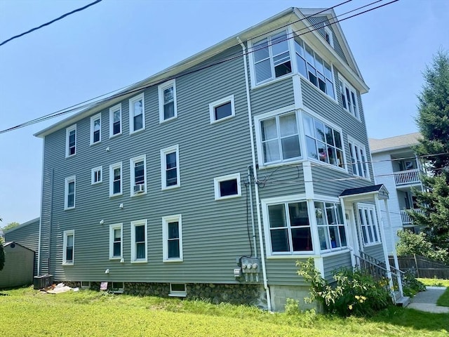 exterior space featuring cooling unit and a yard