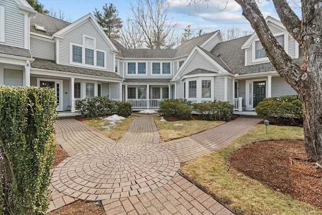 shingle-style home featuring a porch