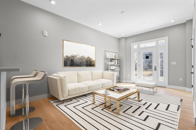 living room featuring light wood-style floors, baseboards, and recessed lighting