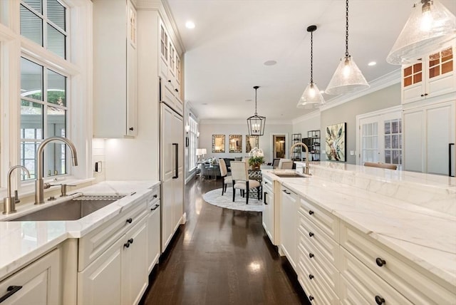 43 Bristol Rd, Wellesley, MA 02481 - kitchen featuring ornamental molding, dark wood-type flooring, light stone countertops, hanging light fixtures, and glass insert cabinets