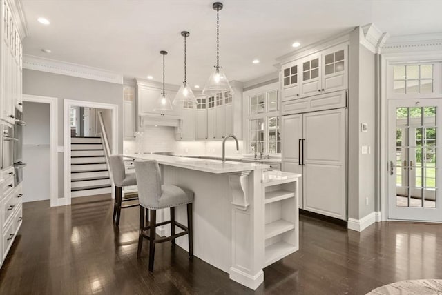 43 Bristol Rd, Wellesley, MA 02481 - kitchen featuring dark wood finished floors, white cabinets, ornamental molding, a warming drawer, and glass insert cabinets