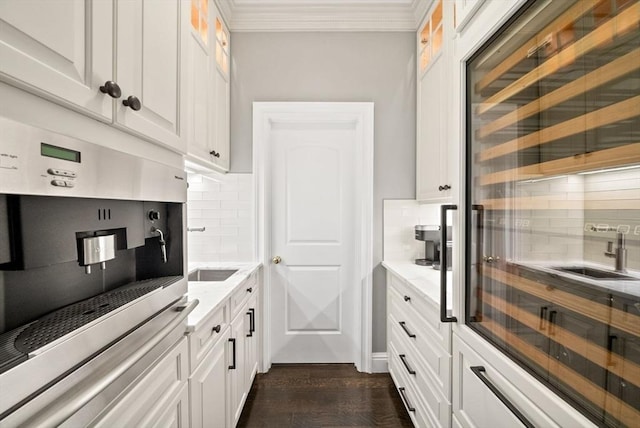 43 Bristol Rd, Wellesley, MA 02481 - kitchen featuring backsplash, white cabinetry, ornamental molding, and glass insert cabinets