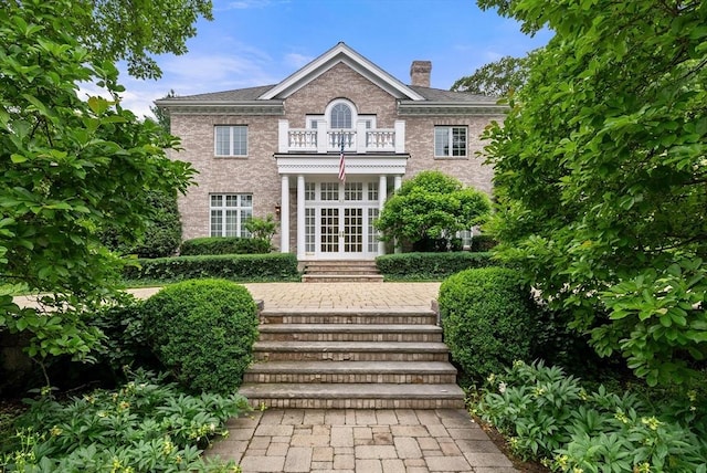 43 Bristol Rd, Wellesley, MA 02481 - back of house with a balcony, french doors, a chimney, and brick siding