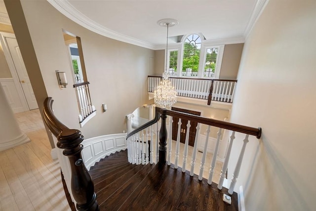43 Bristol Rd, Wellesley, MA 02481 - stairway with wood finished floors, ornamental molding, and a chandelier