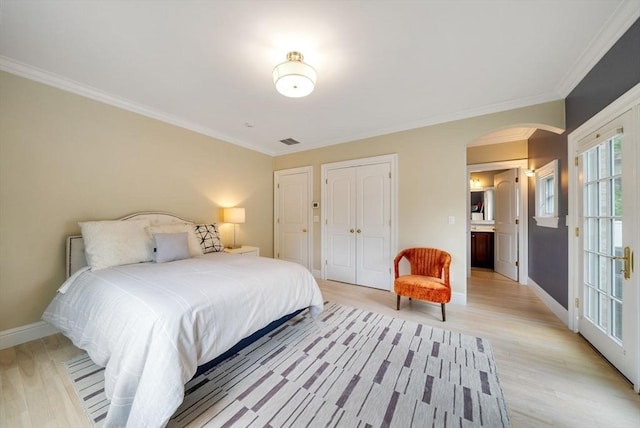 43 Bristol Rd, Wellesley, MA 02481 - bedroom with arched walkways, light wood-style flooring, crown molding, and a closet