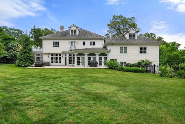 43 Bristol Rd, Wellesley, MA 02481 - back of property with french doors, a hot tub, a patio area, and a chimney