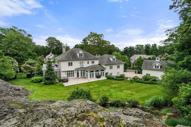 43 Bristol Rd, Wellesley, MA 02481 - rear view of property with a patio area, a chimney, and french doors
