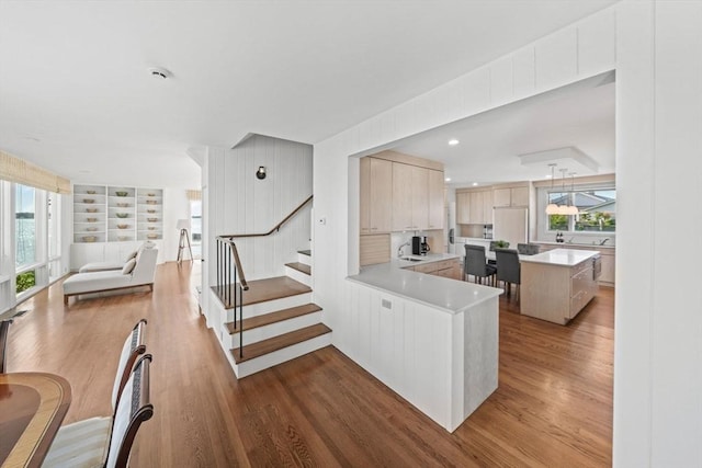 124 William St, Dartmouth, MA 02748 - kitchen with light countertops, built in refrigerator, wood finished floors, open floor plan, and a center island