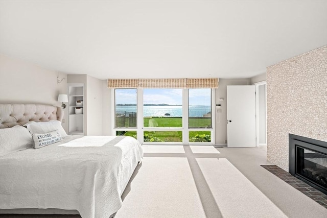 124 William St, Dartmouth, MA 02748 - bedroom featuring a water view, carpet, and a tile fireplace