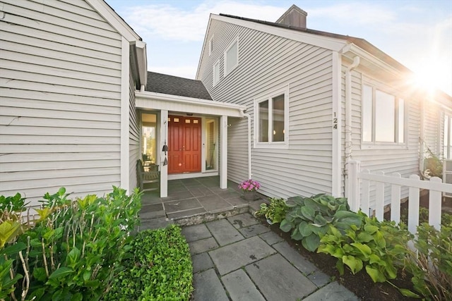 124 William St, Dartmouth, MA 02748 - property entrance featuring a chimney and roof with shingles