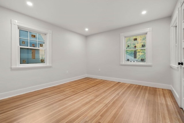 spare room with light hardwood / wood-style flooring