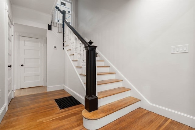 stairs with hardwood / wood-style flooring