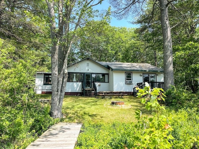 5 Maguire Rd, Ashburnham, MA 01430 - rear view of house with an outdoor fire pit, a lawn, a deck, and cooling unit