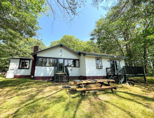 5 Maguire Rd, Ashburnham, MA 01430 - back of property with a wooden deck, a lawn, a chimney, and cooling unit