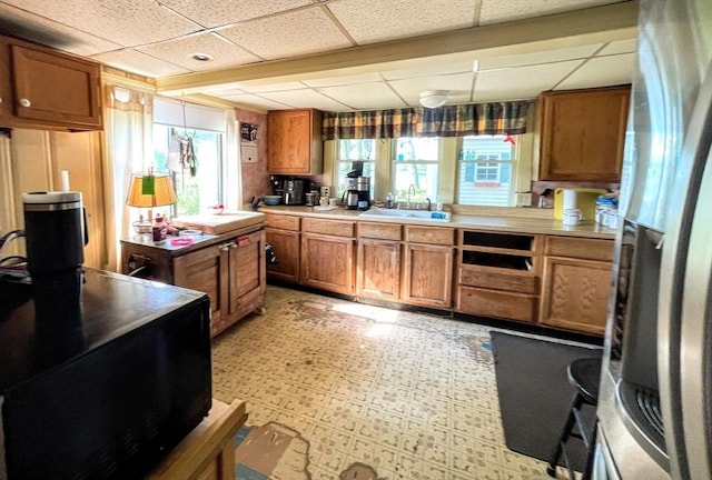 5 Maguire Rd, Ashburnham, MA 01430 - kitchen with freestanding refrigerator, brown cabinetry, healthy amount of natural light, a paneled ceiling, and light floors