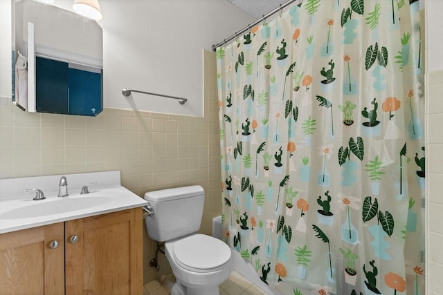 483 Beacon Unit 63, Boston, MA 02115 - bathroom featuring tile walls, vanity, shower / bath combination with curtain, tile patterned floors, and wainscoting