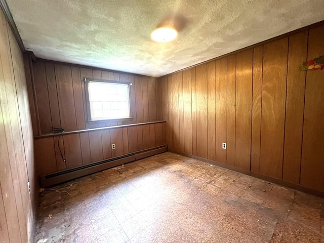 31 Dix Rd, Woburn, MA 01801 - unfurnished room featuring a textured ceiling, a baseboard heating unit, tile patterned floors, and wooden walls