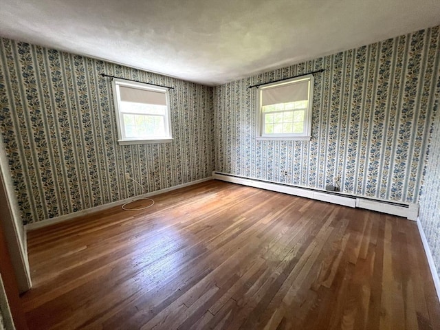 31 Dix Rd, Woburn, MA 01801 - empty room with baseboard heating, wallpapered walls, and wood finished floors