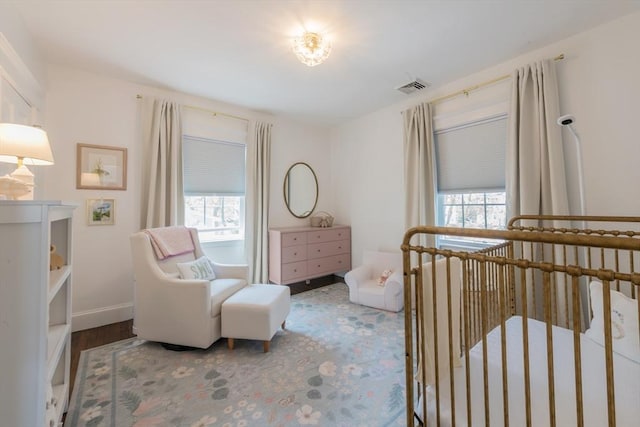 73 Harold St, Milton, MA 02186 - bedroom with a crib, baseboards, and wood finished floors