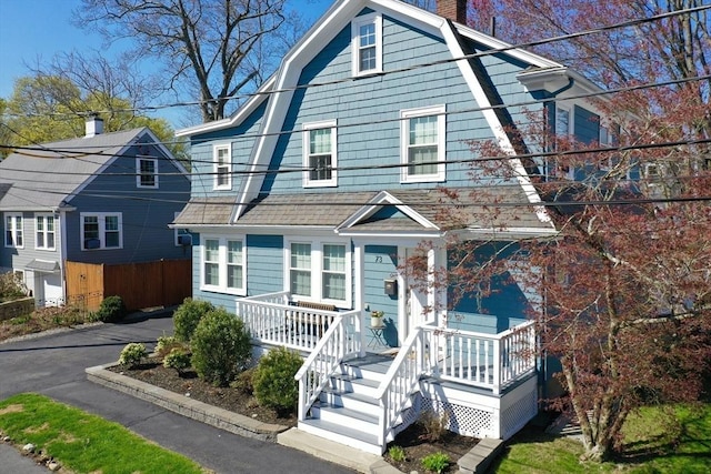 73 Harold St, Milton, MA 02186 - dutch colonial with a gambrel roof, a chimney, covered porch, and fence