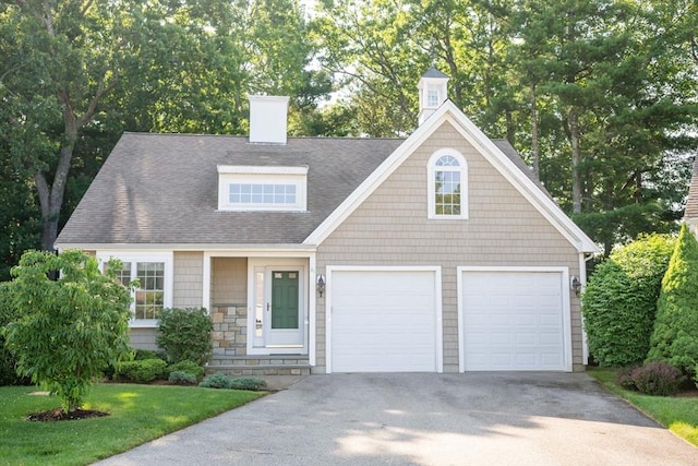 31 Mulligan Dr Unit 31, Weymouth, MA 02190 - view of front of house featuring asphalt driveway, a chimney, and roof with shingles