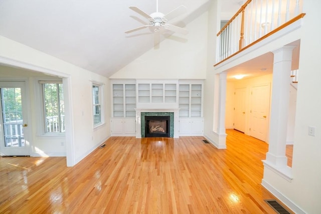 31 Mulligan Dr Unit 31, Weymouth, MA 02190 - unfurnished living room featuring light wood-type flooring, high vaulted ceiling, a ceiling fan, a premium fireplace, and built in shelves