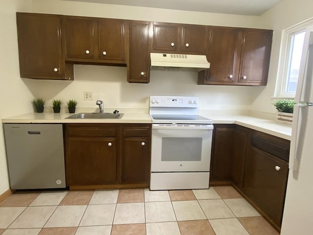 kitchen featuring light countertops, white appliances, a sink, and under cabinet range hood