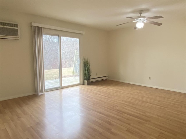 spare room featuring baseboards, ceiling fan, a wall mounted air conditioner, light wood-style floors, and a baseboard heating unit