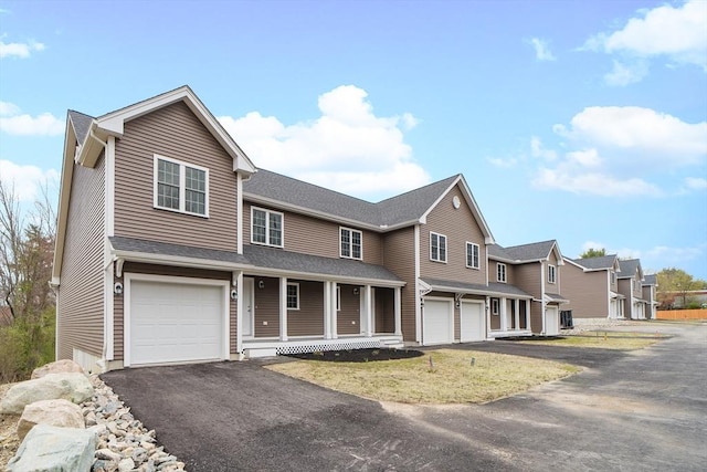 view of front of home featuring covered porch and a garage