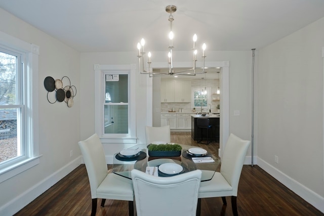 dining room with a chandelier and dark wood-type flooring