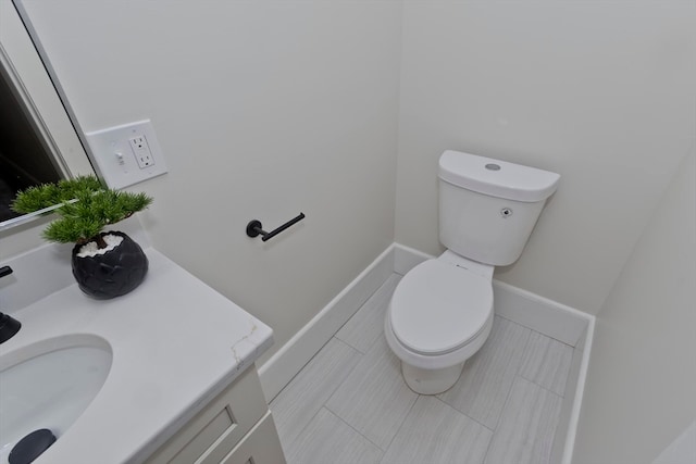 bathroom with vanity, toilet, and tile patterned flooring