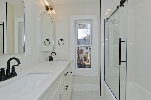 bathroom featuring vanity and combined bath / shower with glass door