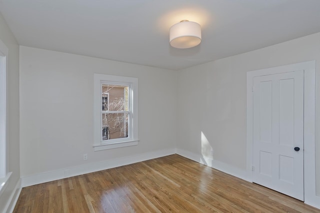 empty room with light hardwood / wood-style flooring