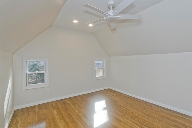 additional living space with ceiling fan, light wood-type flooring, and vaulted ceiling