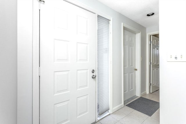 hallway featuring light tile patterned floors