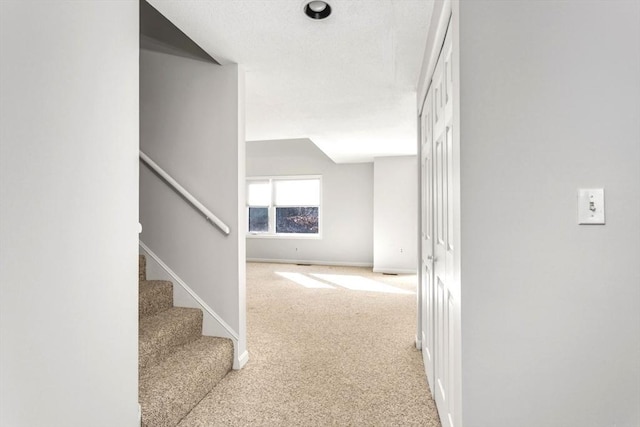 corridor with light colored carpet