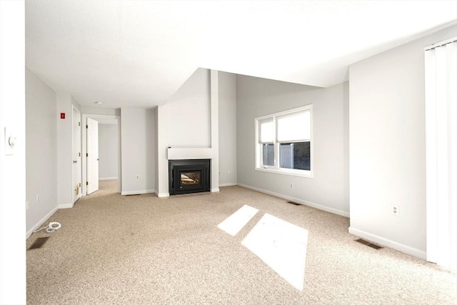 unfurnished living room with light colored carpet