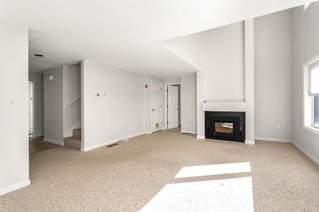 unfurnished living room with light carpet