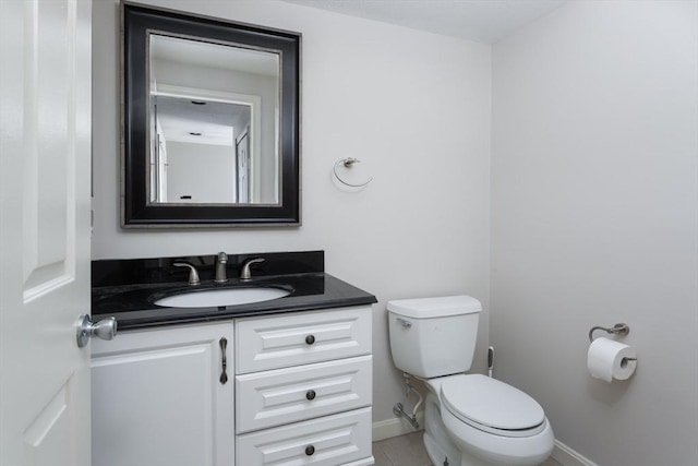 bathroom featuring toilet, tile patterned floors, and vanity