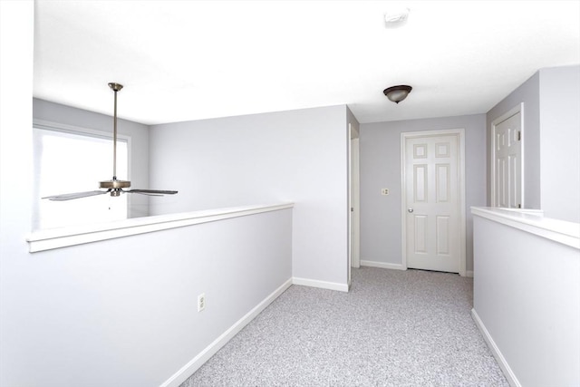 hall with light colored carpet