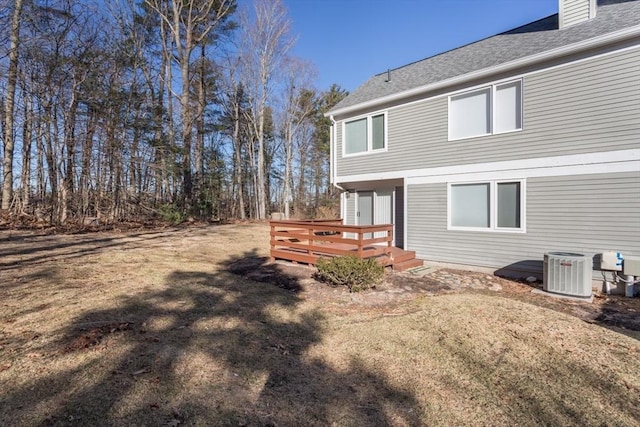 back of house featuring central AC, a yard, and a deck