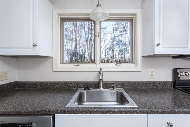 kitchen with sink, white cabinets, dishwashing machine, and pendant lighting